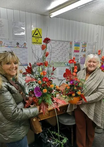 Past autumn flower school class where students made a pumpkin arrangement